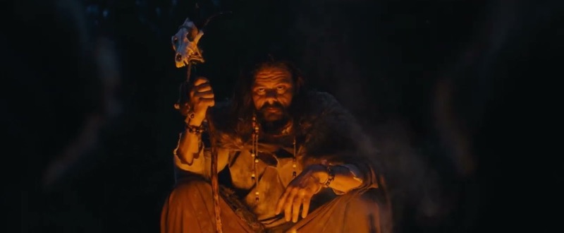 A firelit seer holding a staff crowned with an animal skull, a still from Think You Know Ireland.